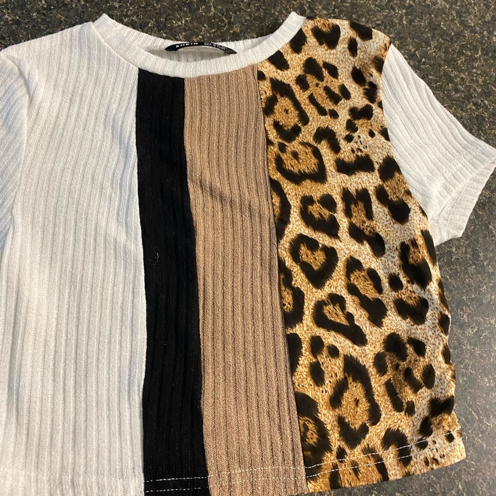 One crop top shirt and it’s from SHEIN In great and it has animal print on it.